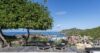 Terrace of a St Barts villa with sun loungers overlooking Gustavia harbor and Caribbean hills.