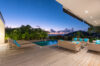 Terrace lounge of a St Barts villa with pool, turquoise cushions, and panoramic sunset views over the Caribbean Sea.