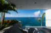 Terrace with lounge chairs and tropical plants overlooking the Caribbean Sea at St Barts villa