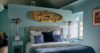 Cozy bedroom with artistic wall décor and plush bedding in private villa rental St Barts