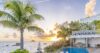 Tranquil poolside scene with loungers facing the calm blue ocean and horizon