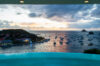 Extraordinary sunset casting warm, vibrant hues over the villa and surrounding landscape, creating a breathtaking and serene atmosphere