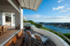 Lounge area on a terrace, furnished with comfortable seating and overlooking a beautiful panoramic view