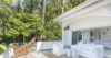 White villa terrace with hammock, outdoor sofa, and tropical palm backdrop at private St Barts vacation rental