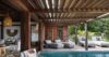 Shaded poolside lounge with cushioned chairs at private villa rental in St Barts