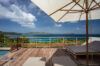 Sun terrace at luxury villas st barts with loungers overlooking turquoise ocean.