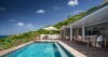 Elegant poolside terrace at St Barts villa with shaded dining area and hillside views