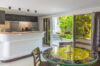 Cozy kitchen and dining area in a St Barts villa with colorful mosaic table and garden views