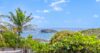 Caribbean Sea view from a St Barts villa surrounded by lush tropical greenery and palm trees