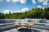 Stylish open-air lounge with modern sofas and a central table for relaxation.