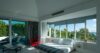 Modern bedroom design featuring large windows framing stunning natural scenery.