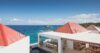 Clifftop St Barts villa with red rooftops and open-air dining terrace overlooking the sea