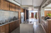 Modern kitchen in St Barts villa with wood cabinetry, central island, and sleek design
