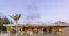 Contemporary St Barts villa exterior at dusk with open terraces and tropical landscaping
