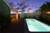Glowing private pool at a St Barts villa rental illuminated under twilight skies.