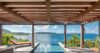 Infinity pool under a shaded pergola with panoramic ocean views at a private villa in St Barts.