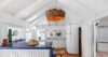 Bright villa kitchen with vaulted ceiling, blue tile counter, and rustic wicker lighting in a St Barts vacation rental.
