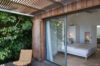 Bedroom with sliding glass doors opening to private terrace at St Barts villa rental