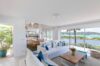 Lounge room featuring large windows that showcase a stunning view of the outdoors