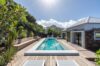 Beautiful pool nestled within lush natural surroundings, creating a serene oasis.