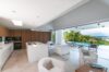 Lounge area inside a beautiful modern villa, featuring stylish furniture and contemporary design elements.
