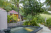 Secluded jacuzzi surrounded by tropical gardens and palm trees in a private St Barts villa rental.