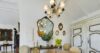 Elegant dining area with antique French mirrors, chandelier lighting, and vintage armoire in a luxury villa in St Barts.