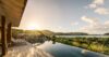 Poolside lounge area with comfortable seating overlooking a stunning natural view