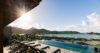 Stunning scene showcasing an infinity pool that blends seamlessly into the surrounding lush nature, creating a tranquil and picturesque view