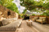 Stylish garden lounge with cozy seating, nestled among plants and natural beauty