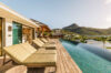 Luxurious sunbathing zone by the pool, offering beautiful views and a calming atmosphere.