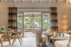 Stylish villa living area in St Barts opening to a terrace with plunge pool and tropical garden views.