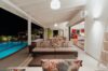 Elegant villa lounge area in St Barths with breezy seating overlooking turquoise waters.