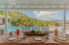 Luxury villa terrace in St Barthelemy with cushioned seating and endless blue waters.