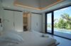 Bright villa bedroom with minimalist design, poolside terrace access, and tropical garden view in St Barts