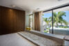 Bedroom with large windows and palm tree views at private villa rental in St Barts