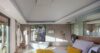 Bright villa bedroom with king bed, freestanding bathtub, and garden views in St Barts rental.