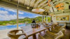 Private villa poolside deck in St Barts with loungers and sweeping coastal vistas.