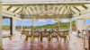 Luxury villa pool terrace in St Barts with loungers overlooking turquoise waters.