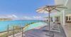 Contemporary St Barts villa kitchen with sleek island counter and ocean views through wide windows.