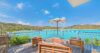 Spacious St Barts villa bedroom with king bed, terrace access, and serene ocean views.