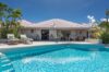 Sun loungers by the infinity pool of a St Barts villa rental with ocean views