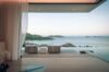 Serene villa terrace in St Barts with flowing curtains, lounge chairs, and panoramic ocean views at dusk.