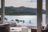 Seaside villa in St Barths with modern terrace overlooking turquoise Caribbean waters.