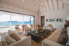 Outdoor villa lounge in St Barts with cushioned seating and sweeping ocean views.