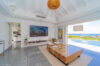 Modern living room in a St Barts villa with open design, ocean views, and natural wood accents