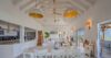 Open-plan dining and living area in a luxury St Barts villa with high ceilings and sea views.