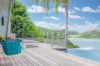 St Barts villa terrace with infinity pool and loungers overlooking the Caribbean Sea.