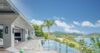 Expansive Caribbean panorama from a St Barts villa overlooking turquoise waters and rugged coastline.