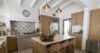 Modern villa kitchen in St Barts with sleek island counter, wood accents, and terrace views.